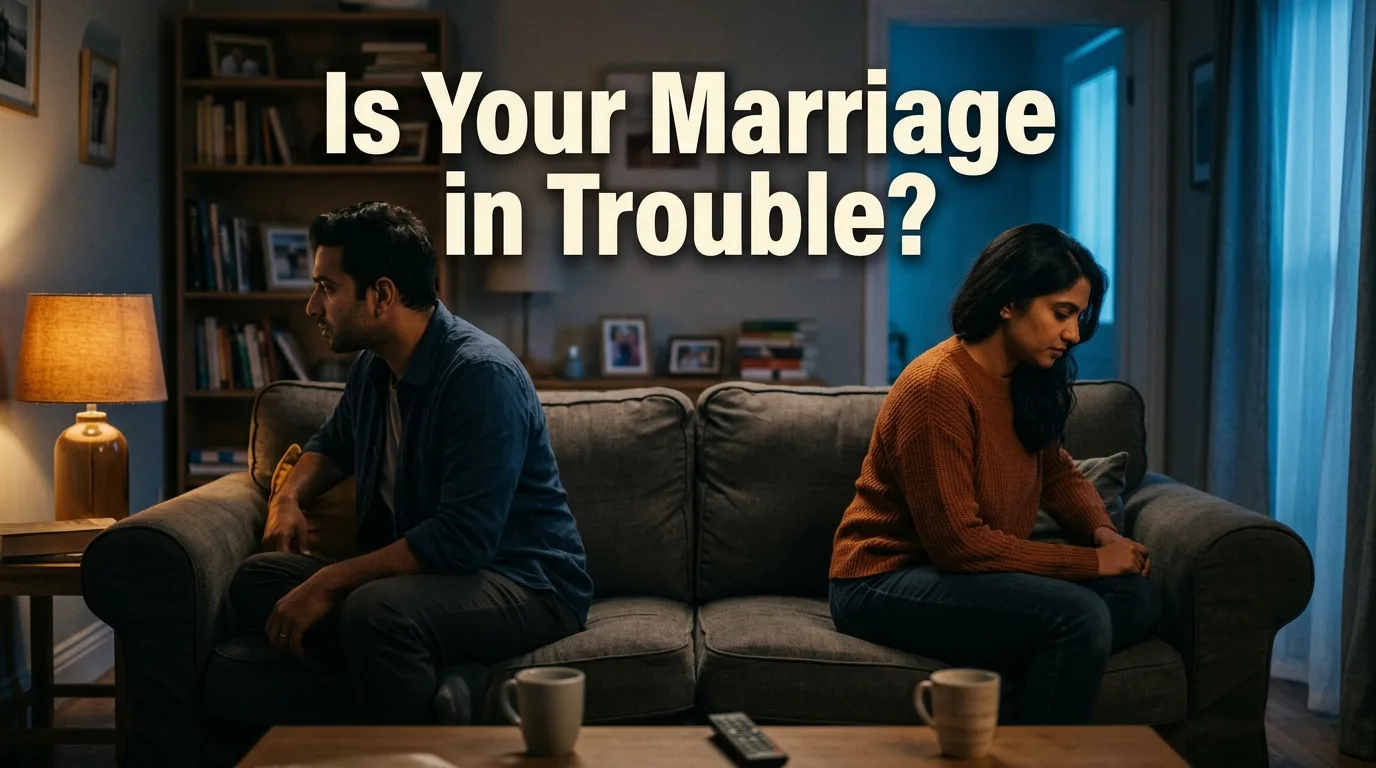 Couple sitting apart on a couch showing signs marriage needs help